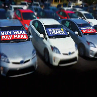 Windshield Banners credit theme on car dealer lot.