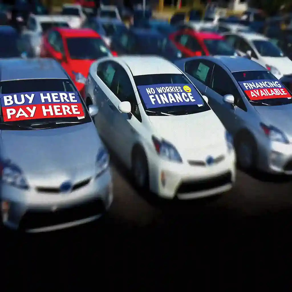 Windshield banners on auto dealer lot.