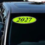 Thumbnail for Car with a bright green oval sticker displaying '2027' on a black car.
