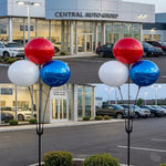 Thumbnail for Red, white, and blue Duraballoons  3 piece clusterin front of a car dealership 