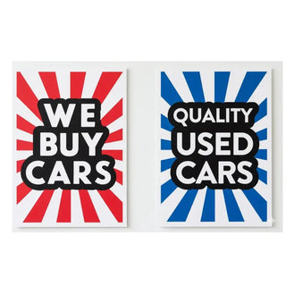 Two signs with red and blue sunburst patterns and text about buying cars.