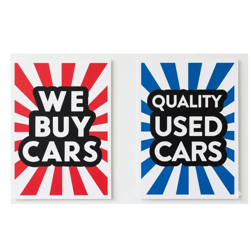 Two signs with red and blue sunburst patterns and text about buying cars.