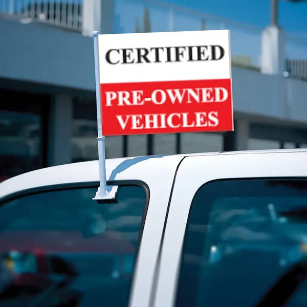 Certfied pre owned clip-on flag on truck at car dealer.