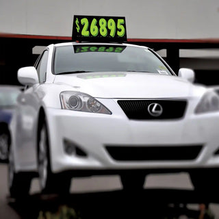 Car Top Sign with pricing numbers on a dealer lot.