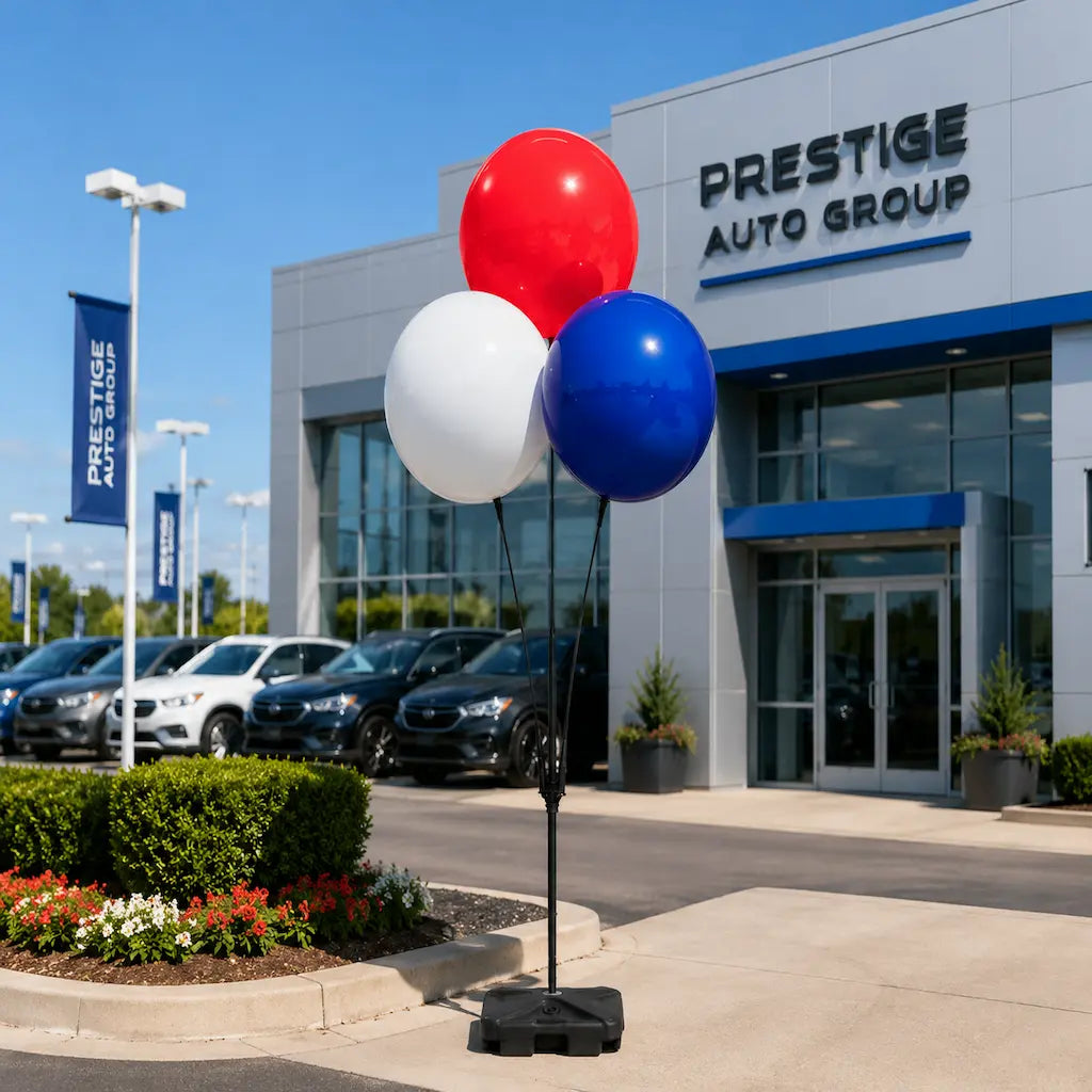 Premium DuraBalloon 3 balloon cluster set in red, white, and blue balloons in front of a car dealership