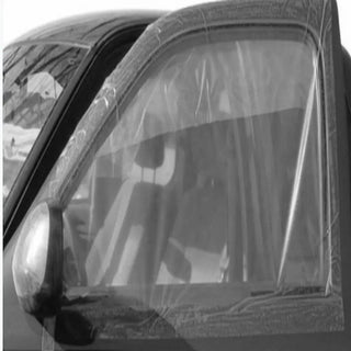 A close-up of a car door window showing crash wrap to protect over the side window.